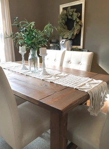 Detailed close-up of handmade bohemian woven table runner with elegant long fringe