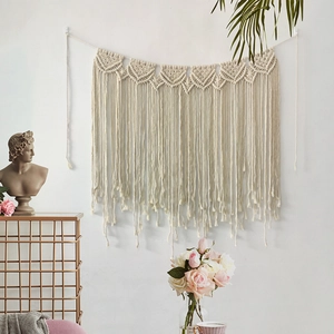 Handmade boho macrame wall hanging with heart weave and fringe for home decor