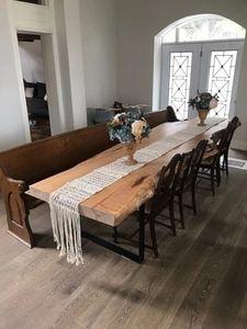 Detail of bohemian fringe table runner on natural live edge wooden dining table