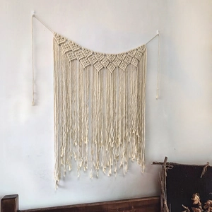 Bohemian handmade woven macrame wall hanging with geometric patterns and long fringes