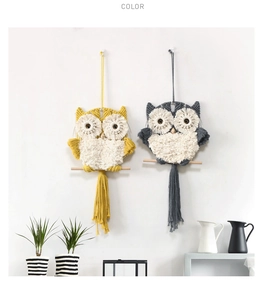 Detail of handmade macrame owl wall hanging featuring cotton ropes and wooden stick