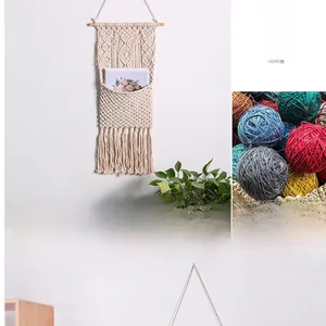Detail of bohemian handmade woven cotton wall hanging storage pocket with long fringe