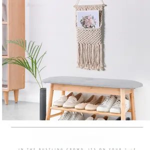 Detail of bohemian hand-woven wall tapestry storage bag with fine white cotton fringes