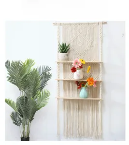 Detail view of handmade macrame weaving patterns and wooden shelves for wall storage