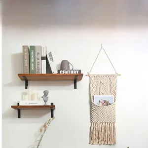 Detail of bohemian macrame wall hanging with hand-woven pocket and elegant tassel fringe