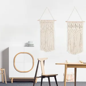 Detail of bohemian macrame wall hanging featuring hand-woven cotton fringe and diamond patterns