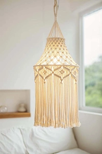 Detail of bohemian hand-woven macrame lampshade with elegant tassels and cream cotton ropes