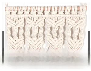 Detail view of handcrafted macrame tapestry showing geometric cotton rope weave and wood pole