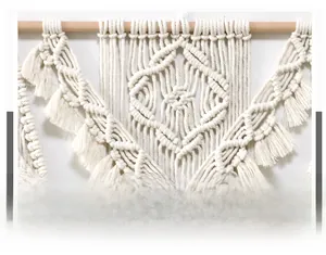 Detailed view of handmade macrame wall hanging with intricate woven cotton rope and fringe