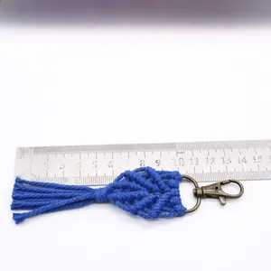 Blue handmade macrame keychain with fringed tassels and vintage bronze clasp detail