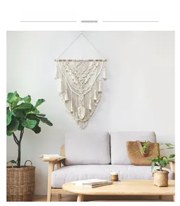 Detailed view of hand-woven cotton macrame wall hanging with intricate diamond patterns