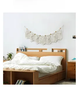 Detail of bohemian handmade woven tapestry featuring 7 triangles and hanging cotton tassels