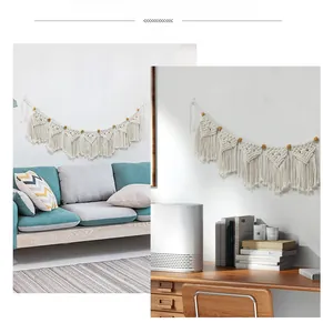Detail of bohemian woven cotton banner with wood beads and handmade tassels decor