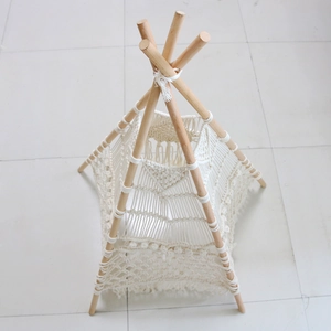 Detailed top view of handmade macramé pet teepee with solid wood frame and tassels
