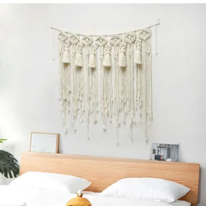 Close-up of bohemian hand-woven tapestry featuring geometric cotton knots and elegant tassels