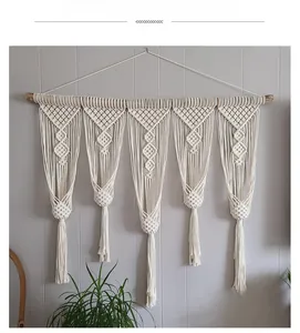 Detail of bohemian handmade wall tapestry with wooden bar and macrame diamond patterns