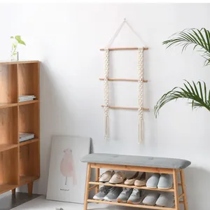 Three-tier macrame wall hanging shelf with natural wooden rods and handwoven cotton rope