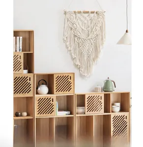 Detailed handmade bohemian macramé wall hanging with intricate cotton rope weaving and tassels