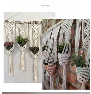 Detail of bohemian hand-woven cotton plant hanger with macrame fringe and wooden rod support