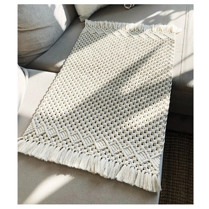 Handwoven macrame table runner with geometric texture and tassels for home decor