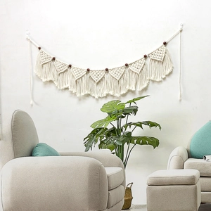 Bohemian handmade macrame wall hanging with white cotton ropes and dark wooden beads