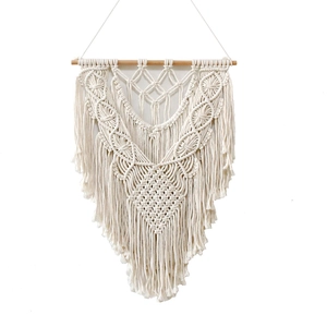 Handmade macrame wall hanging in beige cotton featuring geometric boho weave patterns