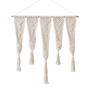 Handmade macrame wall hanging with ivory cotton ropes and boho fringe on a wood rod