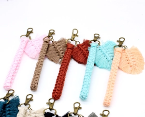 Detail of handcrafted macrame wristlet keychains with leaf fringe and antique bronze clasps