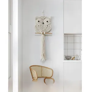 Detailed macro view of owl macrame wall hanging with cotton rope tassels and wooden rod