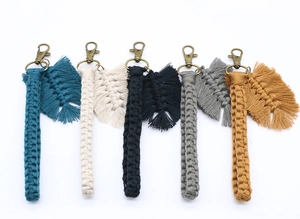 Detail of five bohemian handmade woven keychains in varied colors with metal lobster clasps