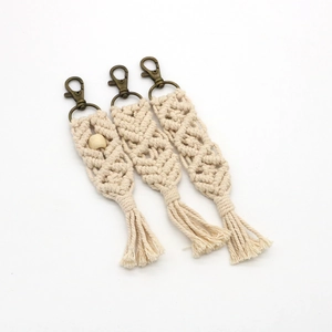 Detailed macro view of bohemian handmade woven cotton rope keychains with fringe tassels