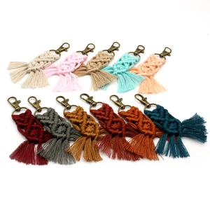 Detailed overhead view showing eleven colorful braided cotton macrame tassel keychains