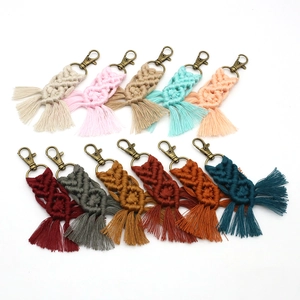 Detailed macro view of multi-color handmade macrame cotton rope keychains with bronze clasps