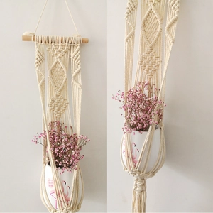 Close-up of bohemian hand-woven cotton macrame plant hanger with detailed diamond patterns
