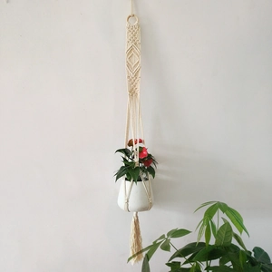 Handmade bohemian cotton rope plant hanger with wooden ring and elegant macrame fringe