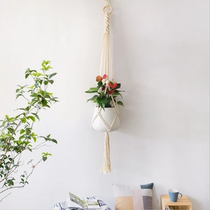 Handmade macramé cotton plant hanger with wooden ring and decorative long tassels