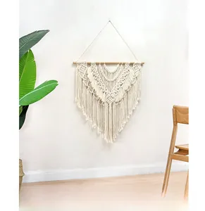 Detailed close-up of bohemian hand-woven tapestry with geometric patterns and tassels