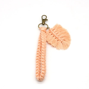 Detail of handmade woven cotton keychain with leaf charm and vintage bronze lobster clasp
