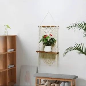 Detail view of Bohemian macrame wall shelf with solid wood board and woven cotton rope