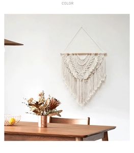 Detail of bohemian hand-woven macrame wall hanging with intricate knots and soft cotton tassels