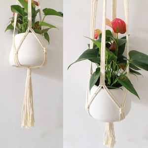 Detail of hand-woven cotton rope plant hanger with tassels and bohemian knotting style