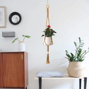 Handmade macrame plant hanger with wooden ring and tassels for indoor garden decor