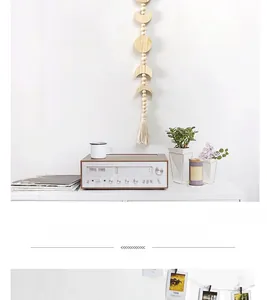 Detail view of moon phase wooden wall hanging with beads and boho tassels for home decor