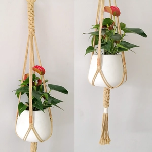 Close-up of handmade macrame plant hangers with woven cotton rope and fringe details