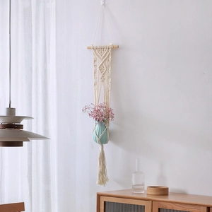Handmade macrame wall hanging plant hanger with cotton rope tassels and ceramic vase
