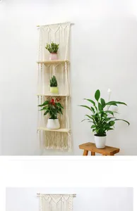 Detail view of a 3-tier macrame wall hanging shelf with boho cotton rope and wood boards