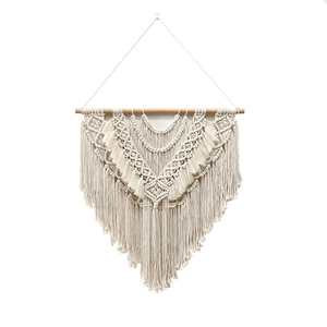 Handmade bohemian macrame wall hanging with natural cotton rope and geometric textures