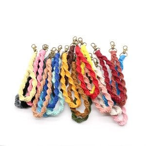 Close-up of bohemian woven cotton keychains with vintage metal clasps in various colors