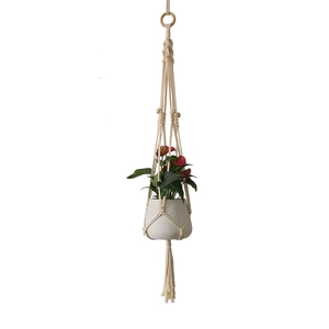 Handmade macrame plant hanger with white cotton rope and wooden ring for home decor