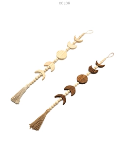 Detailed view of moon phase wooden wall hangings in natural and dark brown wood finishes